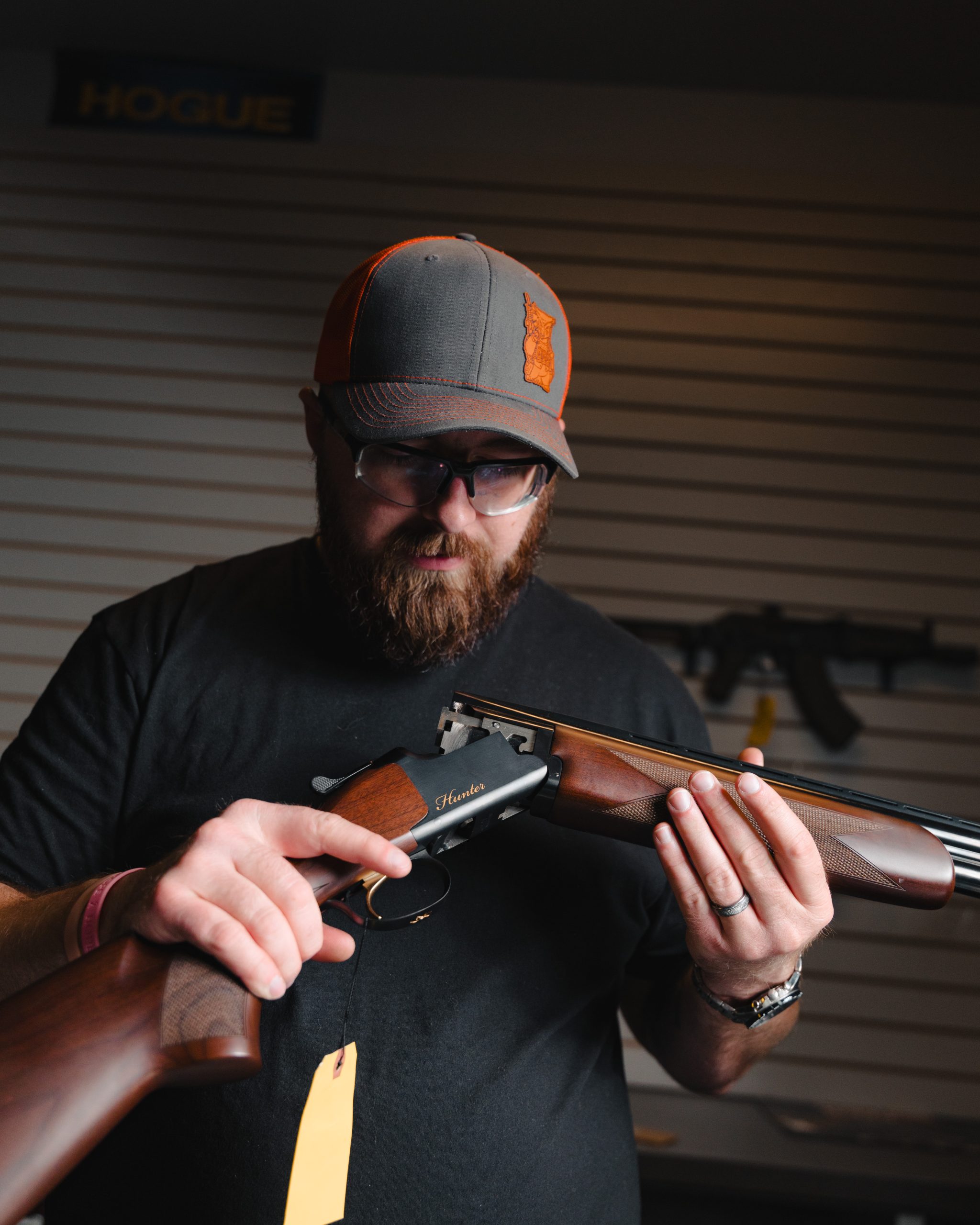 A man inspects an over under shotgun.
